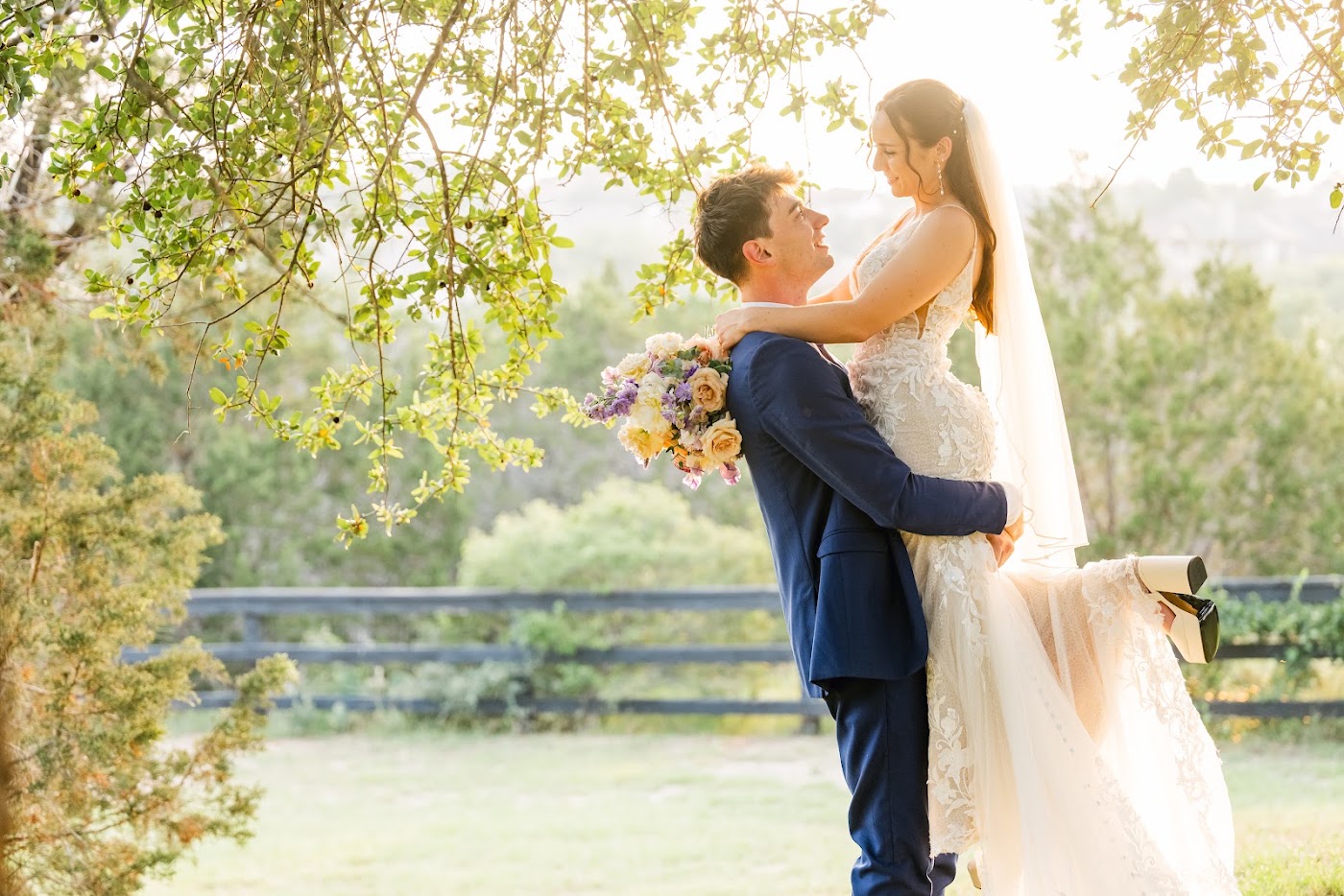 A couple at golden hour beneath a large oak