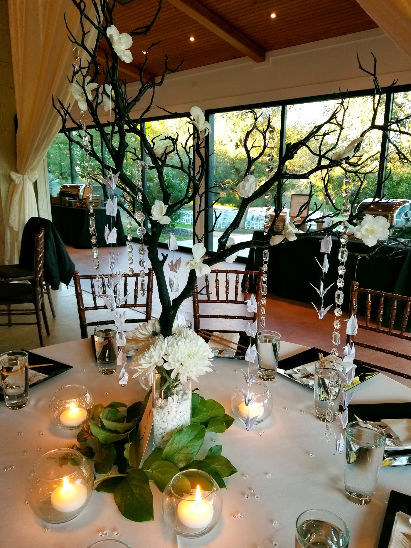 A tall candle centerpiece on a reception table